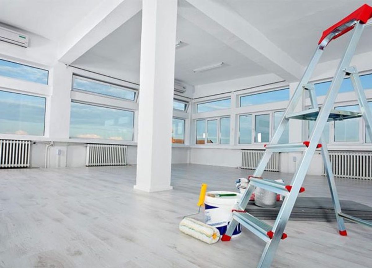 Commercial interior ready for painting with ladder and paint supplies