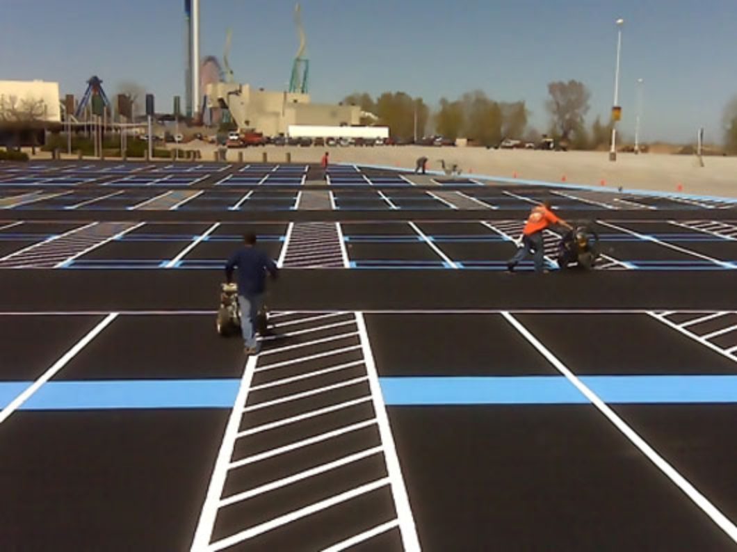 Painters striping a commercial parking lot